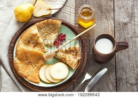 Tasty traditional russian breakfast of slapjack with honey on plate. Rustic style. Space for your.