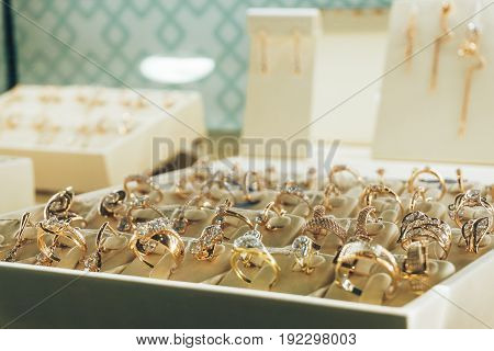 Jewelry in the shop window, Gold rings with diamonds, copy space, selective focus