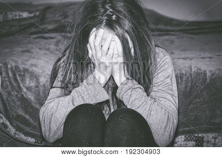 Depression. Depressed woman cover her face with her hands. Loneliness. Sadness. Sad woman.