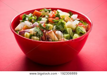 Indian Green Salad also known as Kachumber is a colourful salad dish in Indian cuisine consisting of fresh chopped tomatoes, cucumbers, onions, and sometimes, chili peppers. selective focus