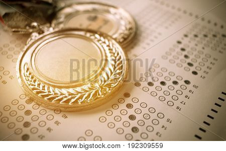 medals awards on exam test answer sheet education and winner award concept vintage tone