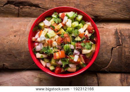 Indian Green Salad also known as Kachumber is a colourful salad dish in Indian cuisine consisting of fresh chopped tomatoes, cucumbers, onions, and sometimes, chili peppers. selective focus