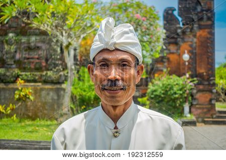 BALI, INDONESIA - MARCH 05, 2017: Unidentified man posing in Pura Ulun Danu Bratan temple on Bali island, Indonesia.