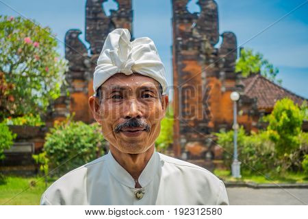 BALI, INDONESIA - MARCH 05, 2017: Unidentified man posing in Pura Ulun Danu Bratan temple on Bali island, Indonesia.