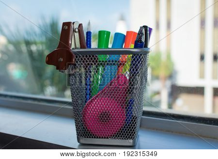colorful office supplies by the window on a sunny afternoon