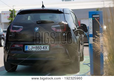 Ljubljana, Slovenia - June 21, 2017: i3 BMW electric car being charged at electric car charging station on 21th of June, 2017 in Ljubljana.