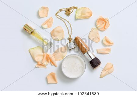 Perfume bottles with flowers petals on white background. Perfumery, cosmetics, jewelry and fragrance collection. Stylized feminine flatlay. Women accessories top view