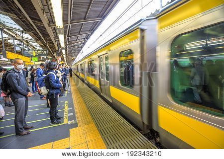 Tokyo, Japan - April 17, 2017: Chuo Line for Akihabara, the yellow line of JR Line, a rail service that crosses east-west Tokyo downtown, arriving at Shinjuku Station, Tokyo's main station.