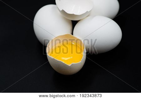 fresh eggs with yellow yalk on the black background