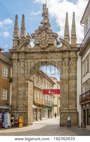 BRAGA,PORTUGAL - MAY 14,2017 - The Arch of Rua Souto (Porta Nova) in the streets of Braga in Portugal. Braga was under the Roman Empire known as Bracara Augusta.