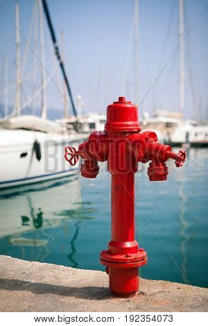 Marine fire hydrant on the quay in front of the yachts, the Mediterranean sea, Greece