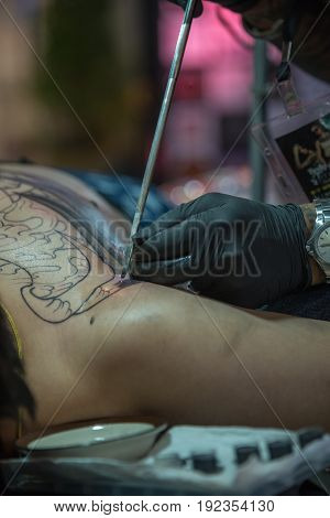 Tattoo Artist Drawing Art On Body