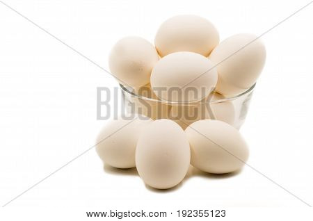 fresh brown eggs in a crystal bowl on the white background