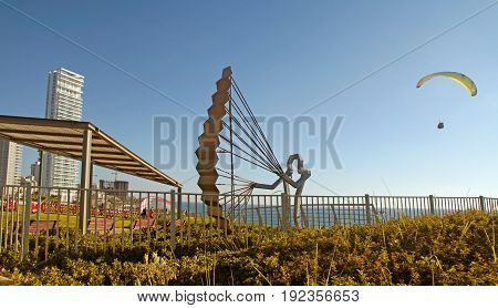 NETANYA, ISRAEL - AUGUST 29, 2015: Modern promenade with paraglider sculpture on Mediterranean sea coast, Netanya, Israel. Coast and quay of Netanya is popular place for paragliding