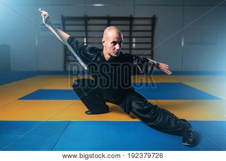 Wushu master training with sword, martial arts