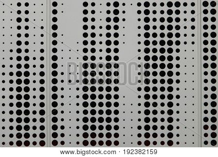 grey metal cladding with circular perforated design