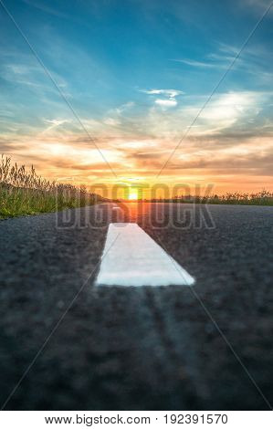 Sunset and lightning in beautiful countryside landscape along the road in the Netherlands.