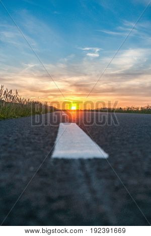 Sunset and lightning in beautiful countryside landscape along the road in the Netherlands.