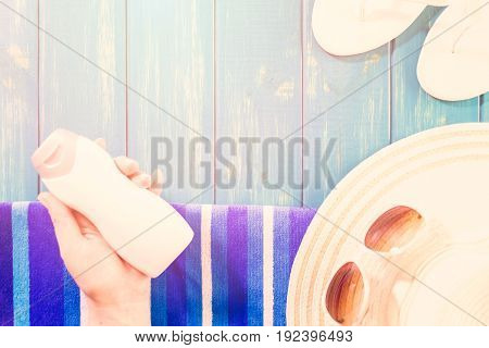 Women's sun hat and beach towel .