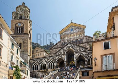 AMALFI, ITALY - MAY 23, 2017: bell tower and central facade of Amalfi Cathedral, dedicated to the Apostle Saint Andrew, Roman Catholic cathedral in the Piazza del Duomo, Amalfi, Italy