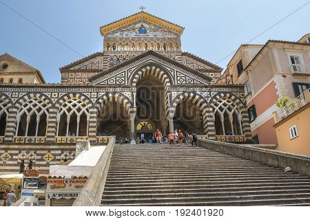 AMALFI, ITALY - MAY 23, 2017: bell tower and central facade of Amalfi Cathedral, dedicated to the Apostle Saint Andrew, Roman Catholic cathedral in the Piazza del Duomo, Amalfi, Italy