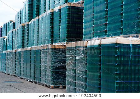 Several stacks of colorful beverage bottle crates outdoors.
