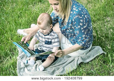 Portrait of beautiful happy mather with baby outdoor, on nature