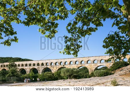 Tourists Go To Ancient Roman Aqueduct Pont Du Gard