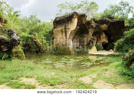 The exploitation of limestone hills canyon forming a unique architectural in Arosbaya Hill Madura Island, Indonesia