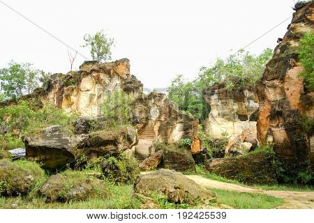 The exploitation of limestone hills canyon forming a unique architectural in Arosbaya Hill Madura Island, Indonesia