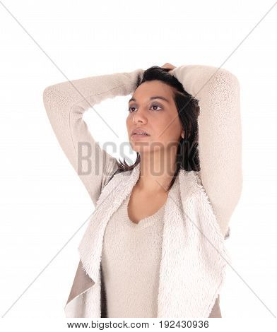 A beautiful young Hispanic woman in a deerskin jacket standing with her hands on her head isolated for white background.