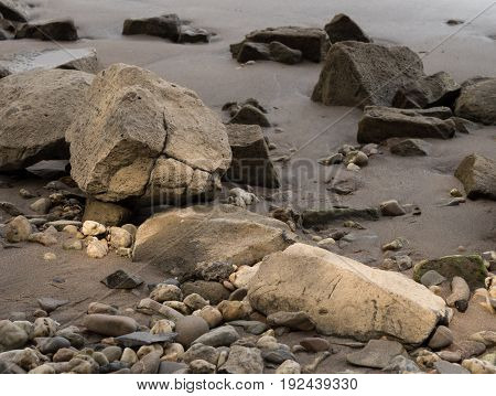 Stones on the banks of the Rhine illuminated by the sunlight Kalkar Germany