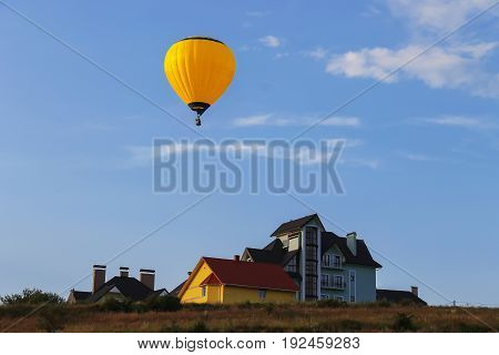 Yellow balloon in blue sky in Schodnica Ukraine