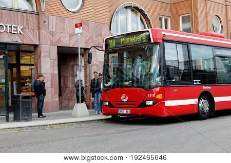 Stockholm Sweden - May 23 2017: One red Stockholm public transport (SL) bus in service on line 114 witrh destination Minneberg at the stop in Alvik.