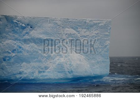 A large tabular iceberg floating in the southern atlantic ocean, near Antarctica.
