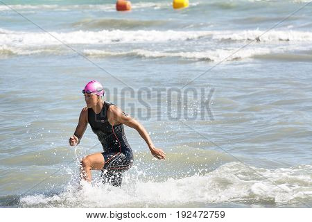 Pescara Italy - June 18 2017: Arrival of Huetthaler Lisa athletes at the end of the swimming test at Ironman 70.3 in Pescara