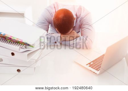 Caucasian businessman asleep at his desk