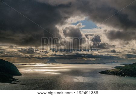 Sharp back-lit image of a Norwegian Fjord early evening.