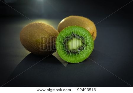 slice of kiwis in studio with light from telephone  light