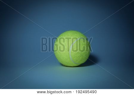 Tennis ball in the dark and blue