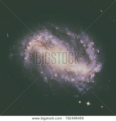 NGC 6217 is a barred spiral galaxy located some 67 million light years away, in the constellation Ursa Minor. Retouched image. Elements of this image furnished by NASA.