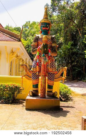 Thai temple with giant and green tree