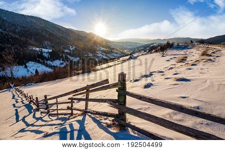 Wooden Fence By In Winter Rural Area