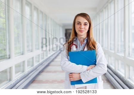 Medical doctor woman over clinic interiers background