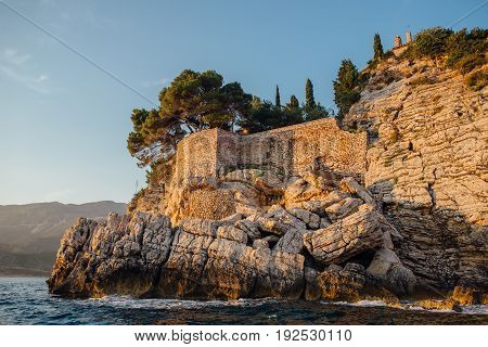 Rocky coast of the Adriatic Sea in Montenegro at sunset, view from the sea