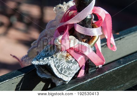 A Padlock Covered With Transparent White Textile And Tied With Soft Color Ribbons