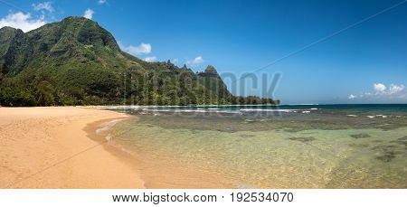 Panoramic view down the sand at Tunnels Beach in summer on Hawaiian island of Kauai on North Shore