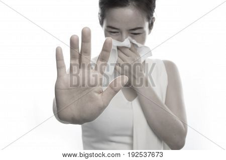 young asian woman sneezing on isolated white background. concept of healthcare.