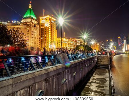 Shanghai, China - Nov 4, 2016: Night view of Sassoon House and Bank of China buildings (left to right) along The Bund on Zhongshan East 1st Road. Some haze can still be seen.