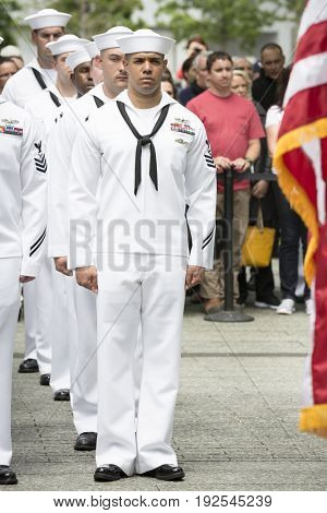Participating U.S. Navy personnel stand at attention at the re-enlistment and promotion ceremony at the National September 11 Memorial site. Fleet Week, NEW YORK MAY 26 2017